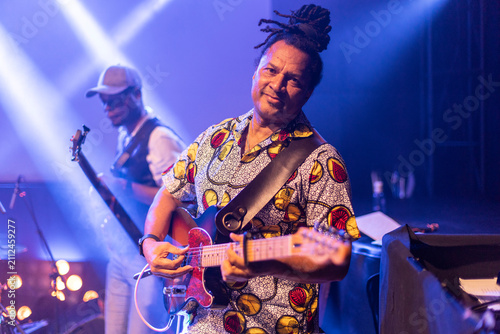 Musician playing electric guitar at live concert