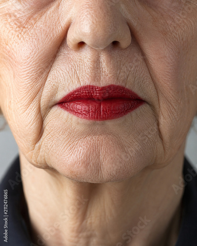 A Study in Aging: Close-up on the weathered lips and facial skin of an elderly woman, emphasizing the textures of time and experience.