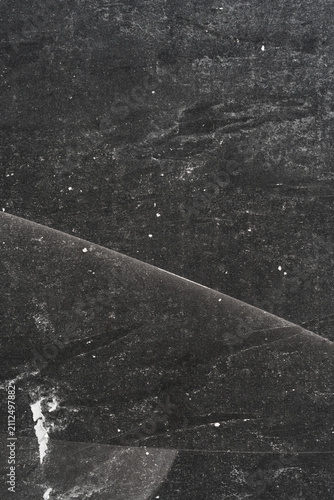 Subtle halftone grunge urban texture with scratches on black background. Distressed overlay texture. Grunge background.