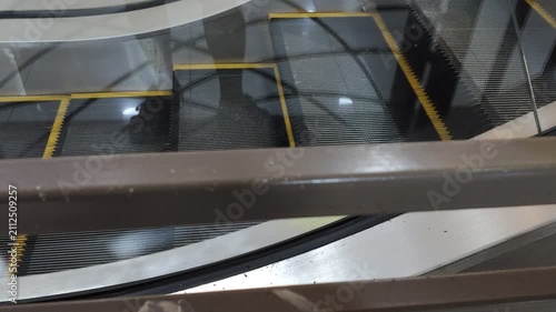 Moving escalator inside a modern shopping mall or commercial building interior