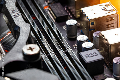 Obraz na płótnie computer motherboard components, showing microchips, circuit traces, capacitors, and connectors for hardware technology, PC building, and microelectronics concept