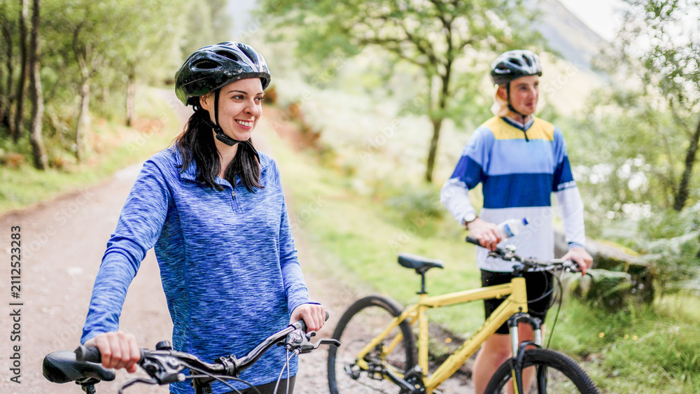 Fototapeta premium Cyclists enjoying scenic forest trail