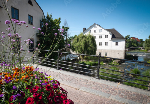 Hiistoric city center with old buildings and flowing river in center of Uppsala. Europe. Sweden.