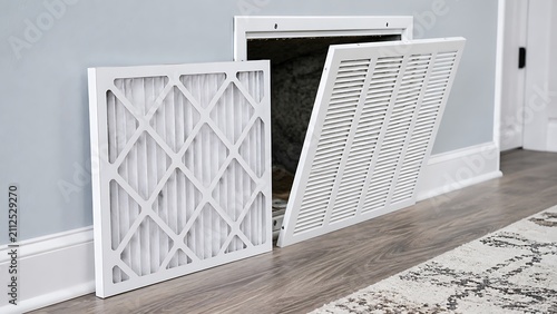 Replacing a dirty air filter in a residential wall mounted heating and cooling ventilation return vent