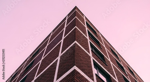 Modern Brick Building Corner Against Pastel Pink Sky