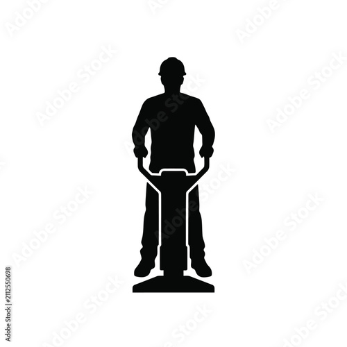 Fotografie Construction worker operating a plate compactor machine in black silhouette labo