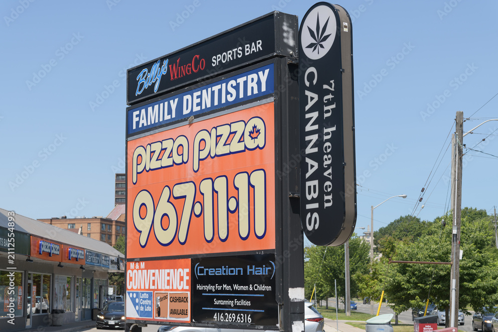 Fototapeta premium road side pylon sign at Kingston Rd and Markham Rd, Scarborough, Toronto (Billy's Wing Co, Pizza Pizza, 7th Heaven Cannabis)