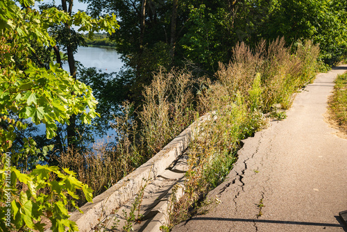 Obraz na plátně an asphalt road closed to traffic, which has been undercut by the Bug River