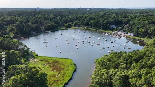 Healthy forest and marsh surrounds the scenic Arey's Pond in Orleans, Cape Cod, MA. This area of New England is a perfect area for sailboats during the warm summer months.