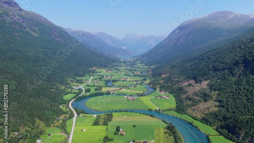 Aerial drone view of a winding river in a mountain valley near Stryn, Norway. Scenic water landscape, high peaks, and popular Scandinavian travel destination.