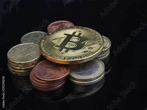Bitcoin gold coin with traditional physical currencies financial concept
