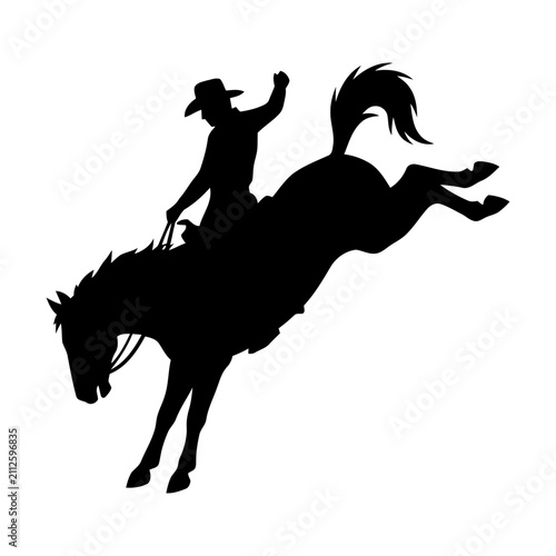 Cuadro en lienzo Black silhouette of a cowboy riding a bucking horse in a wild western rodeo show
