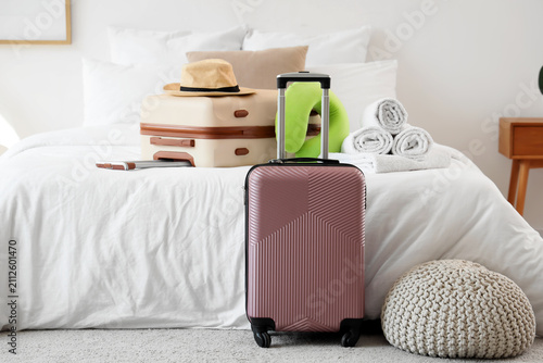 Two suitcases, a straw hat,...