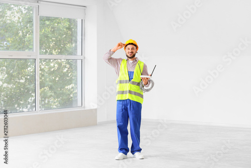 Smiling male electrician in...