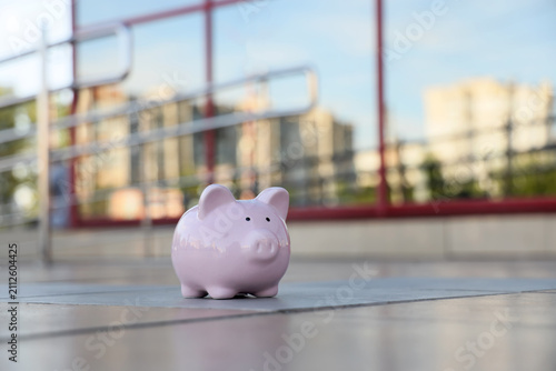 Pink piggy bank on a tiled ...