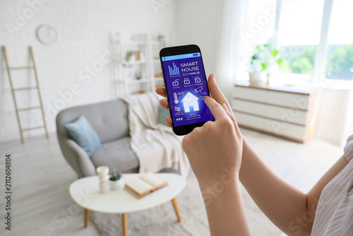 Woman using smart home appl...