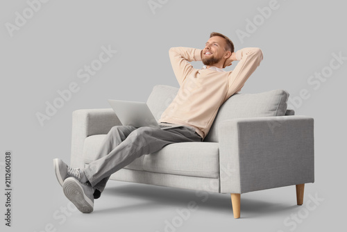 Relaxed young man with lapt...