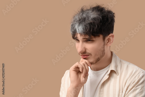 Thoughtful young man with g...