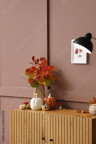 Vase with autumn leaves and...
