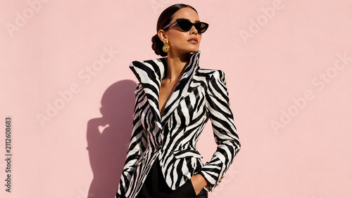 Woman in a zebra jacket and black sunglasses. Ideal for fashion editorials, eyewear campaigns, luxury branding, beauty ads and posters.