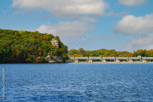 Autumn Landscape with Serene Lake in Park Surrounded by Colorful Trees, Forest, Cloudy Sky and Peaceful Nature View