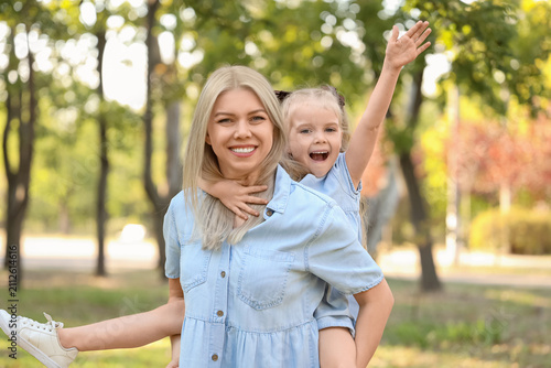 Happy mother with her little daughter in park