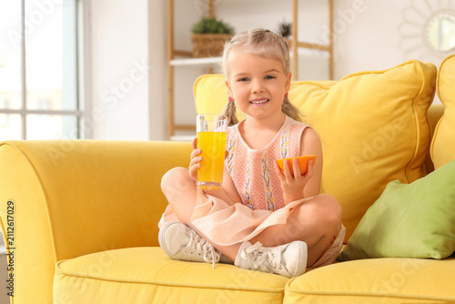 Cute little girl with glass...