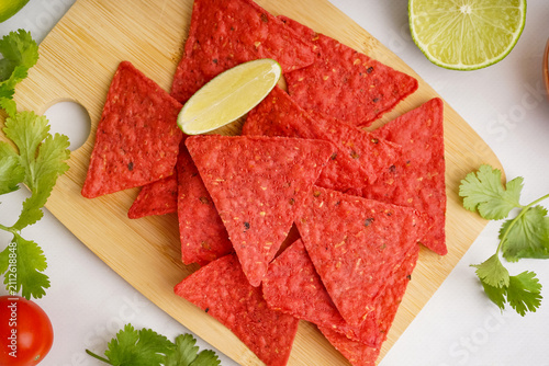 Wooden board with red nacho...