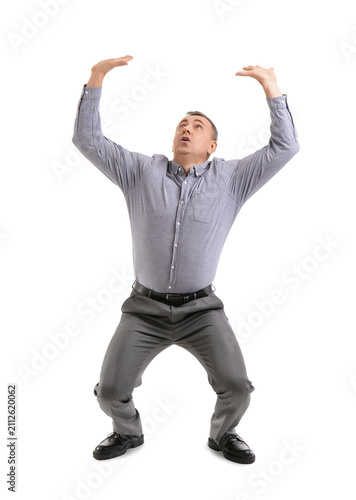 Scared mature man on white ...