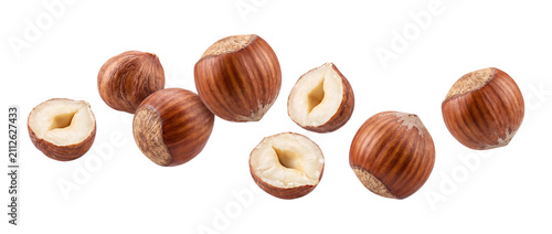 Fotografie Falling hazelnuts whole and halved isolated on transparent background