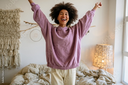 Joyful Woman Jumping On Bed