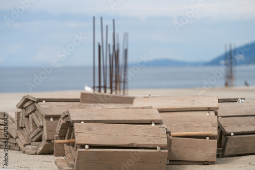 Konstfotografi Rolled-up plank walkways on a sea beach