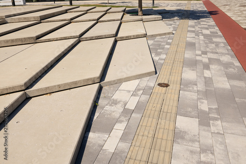 Bild auf Leinwand Modern urban landscape featuring textured concrete steps and patterned pavement