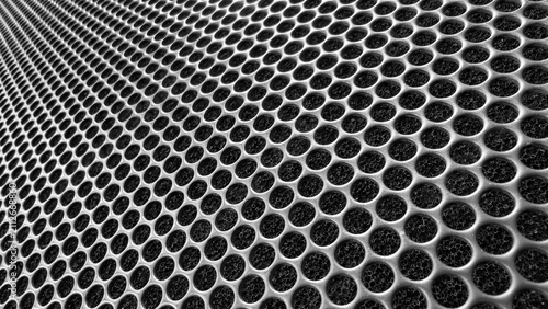 Photography Close up of a perforated metal grid or speaker grill, creating a textured patter