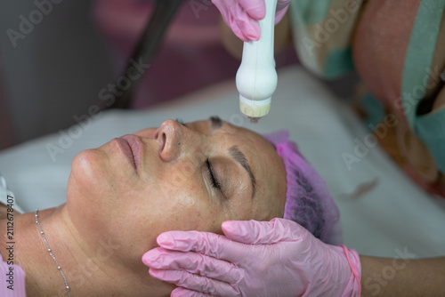 Photos Woman receiving skin rejuvenation facial treatment at spa