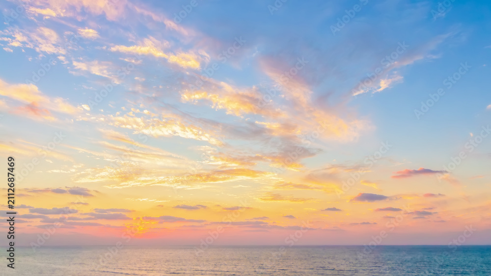 Fototapeta premium Wide horizontal soft focus minimalist sunset landscape sea or ocean, dramatic golden hour clouds, peaceful serene nature background. Copy space for web design, travel banner 