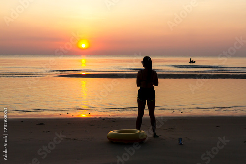 Woman with sunrise and silhouette