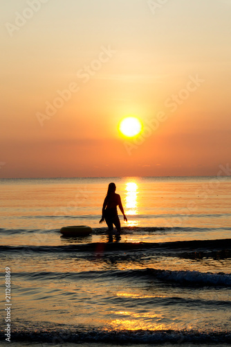 Woman with sunrise and silhouette