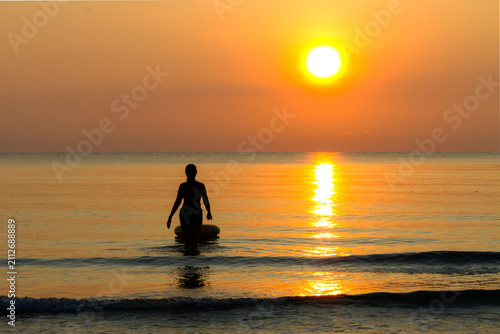 Woman with sunrise and silhouette