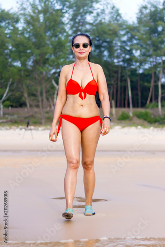Woman with red bikini relax on beach