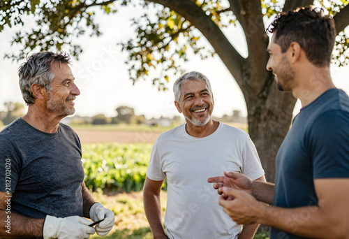 Three smiling men talking o...