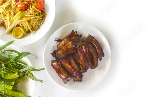 Grilled pork ribs with som tam and fresh vegetables