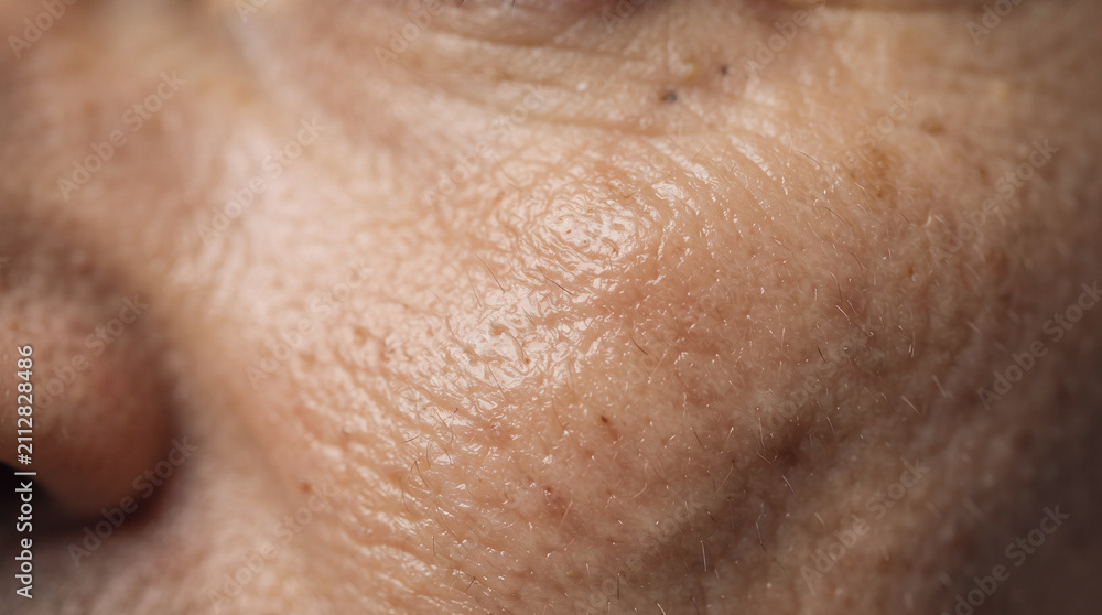 Fototapeta premium Macro View of Aged Skin: Extreme close-up showcasing the intricate texture of mature human skin, highlighting wrinkles, pores, and subtle variations in tone.