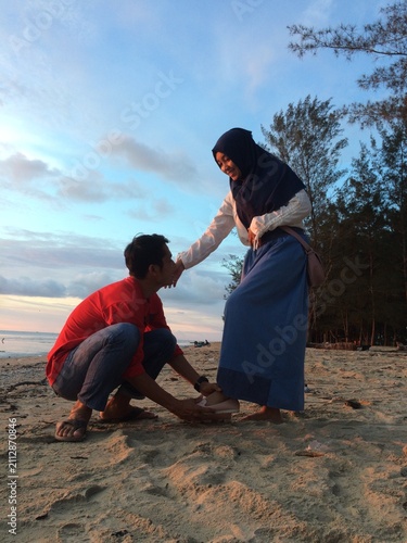 father and son playing on beach