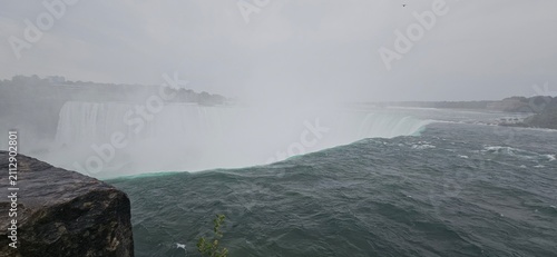 Panoramic view of Niagara Horseshoe Falls edge with thick water mist