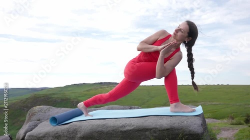 Yoga practice on a mountain top with stretches and poses in open nature