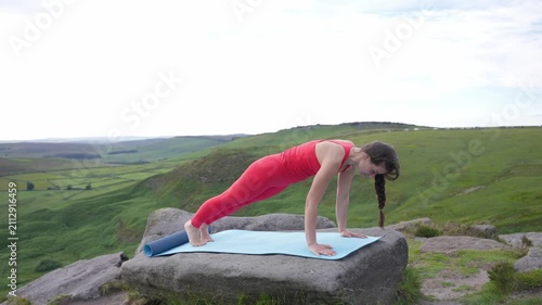 Yoga poses practiced on a mountain top during a cloudy day