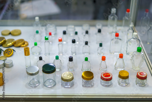 Assorted Empty Glass Bottles and Cosmetic Jars on Display