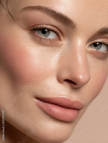 Close up of woman face with flawless skin, natural makeup, and soft expression. image highlights beauty and skincare