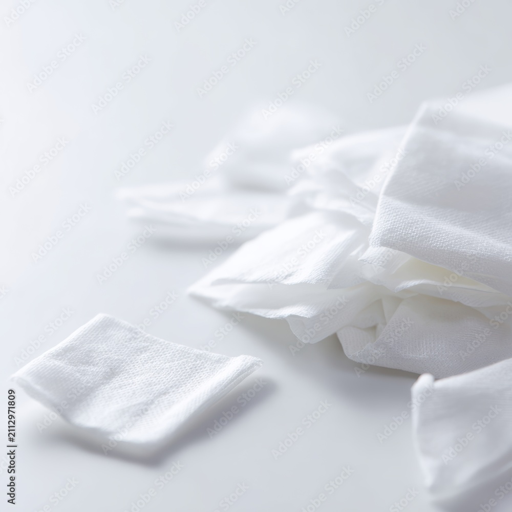 Fototapeta premium disposable wipes scattered on sterile white surface hygiene concept